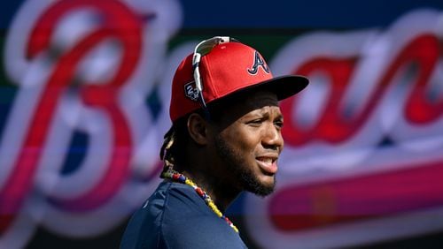 Atlanta Braves right fielder Ronald Acuna Jr. talks with teammates and coaching staff before taking batting practice during spring training workouts at CoolToday Park, Feb. 16, 2024, in North Port, Florida. (Hyosub Shin / Hyosub.Shin@ajc.com)