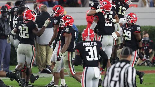 Georgia defenders celebrate stopping Mississippi State on a 4th-and-5 attempt in the final minutes to hold on to a 31-24 victory Saturday, Nov. 21, 2020, in Athens. (Curtis Compton / Curtis.Compton@ajc.com)