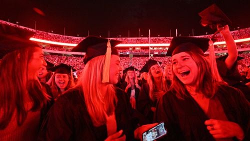 State leaders said a more educated populace is necessary to foster economic growth in Georgia. In this May 2022 photo, University of Georgia graduates celebrate as fireworks conclude the Sanford Stadium ceremony. (Hyosub Shin / Hyosub.Shin@ajc.com)