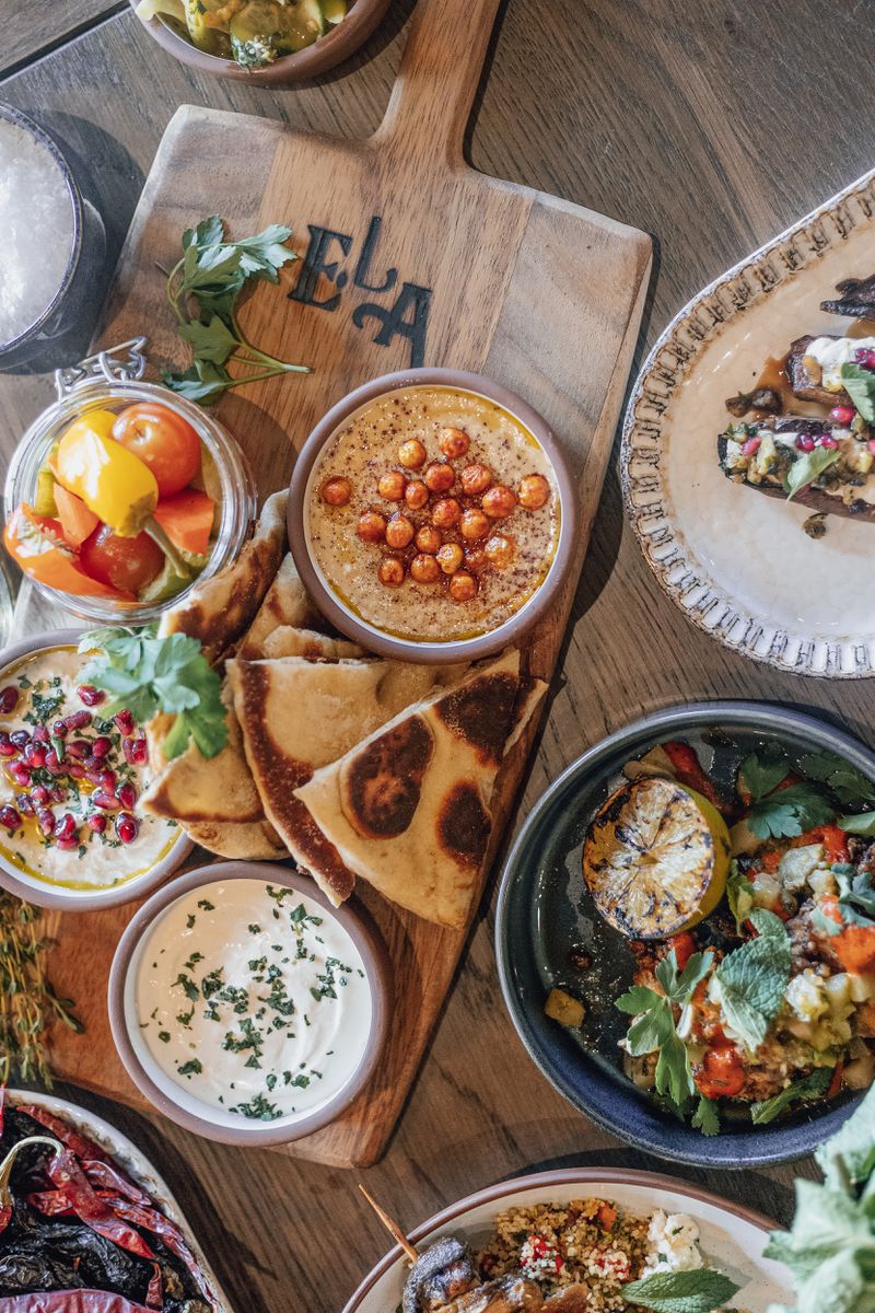 Ela's mezze board includes Persian labneh, smoked eggplant dip, your choice of hummus, pickles and grilled pita. Courtesy of Frankie Cole
