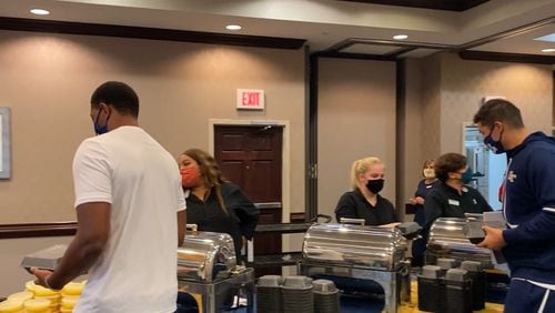 Georgia Tech players fill to-go cartons for their meal prior to their Sept. 12, 2020 game against Florida State in Tallahassee, Fla.
