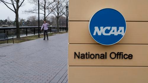 FILE - NCAA signage outside the headquarters in Indianapolis, Thursday, March 12, 2020. A settlement being discussed in an antitrust lawsuit against the NCAA and major college conferences could cost billions and pave the way for a new compensation model for college athletes. (AP Photo/Michael Conroy, File)