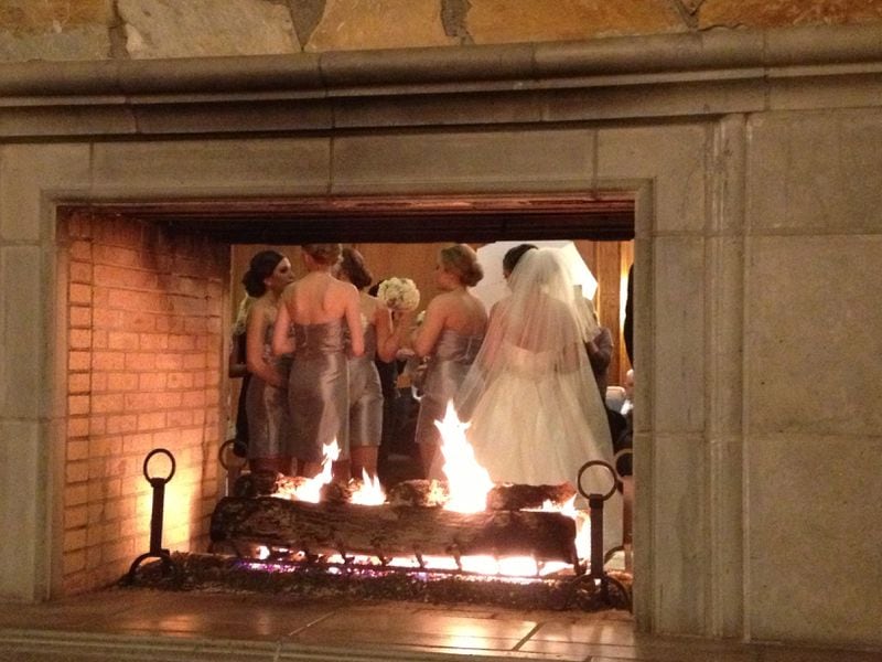 The wedding party took photos in front of a lovely fireplace. My wife Helen was waiting for me while I was interviewing attendees and took this behind the scenes pic. (Nobody was allowed to take pictures of the formal shots except the folks hired to do so.)