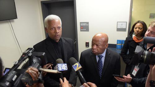 Democratic U. S. Congressmen Hank Johnson, left, and John Lewis talk with the media following a meeting inside the Customs and Border Protection office at Hartsfield Jackson International airport on Jan. 25, 2017.