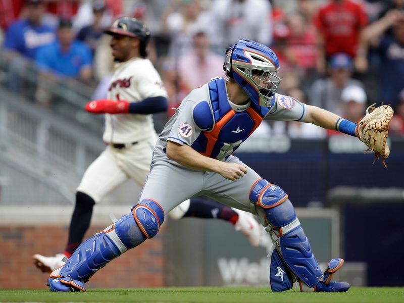 New York Mets catcher Patrick Mazeika waits for the ball as Braves second baseman Ozzie Albies scores behind him in the first inning Sunday, Oct. 3, 2021, at Truist Parl in Atlanta. (Ben Margot/AP)
