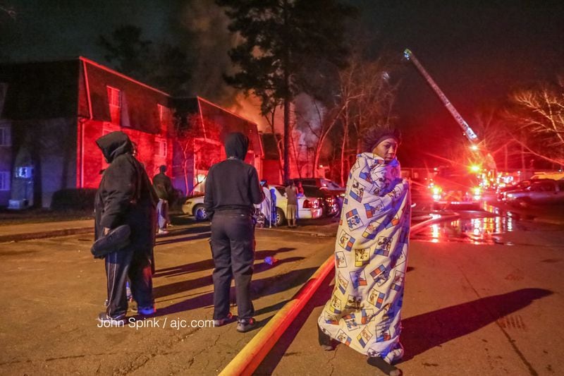 Firefighters rescued multiple people from a raging apartment fire early Wednesday in DeKalb County, officials said. JOHN SPINK / JSPINK@AJC.COM