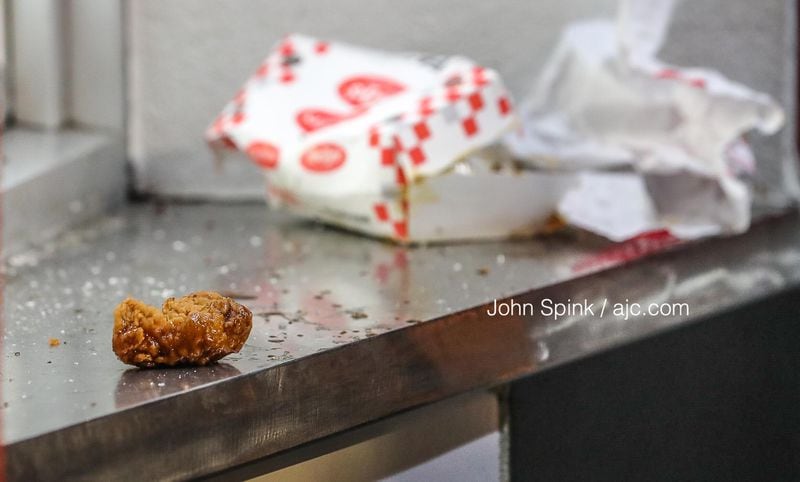 Discarded chicken is left on the counter after a Checkers employee allegedly shot an angry customer at the Candler Road location, a manager told Channel 2 Action News. 