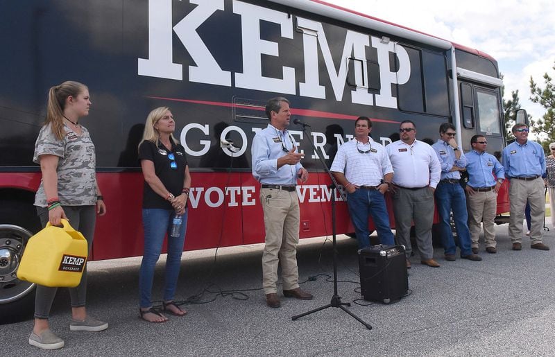 Gov. Brian Kemp is traveling the state in an enormous campaign bus, often with family. With him one one stop are his daughter Lucy and his wife, Marty. AJC photo: Ryon Horne