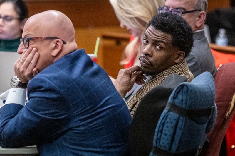 Deamonte Kendrick sits with his attorneys Monday morning ahead of opening statements in the YSL trial at Fulton County Courthouse on Monday, Nov. 27, 2023. (Steve Schaefer/steve.schaefer@ajc.com).