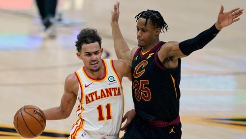 Atlanta Hawks' Trae Young (11) drives to the basket against Cleveland Cavaliers' Isaac Okoro (35) in the second half of an NBA basketball game, Tuesday, Feb. 23, 2021, in Cleveland. The Cavaliers won 112-111. (AP Photo/Tony Dejak)