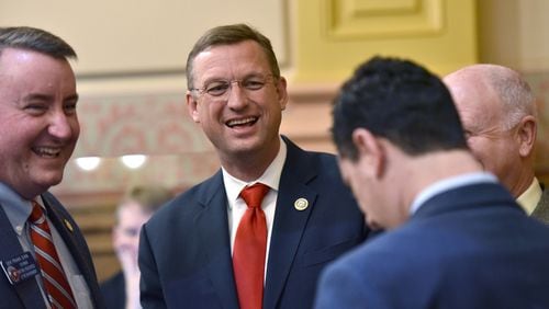 U.S. Rep. Doug Collins, R-Gainesville, (second from left) chats with Sens. Frank Ginn (left) and Butch Miller (right) on the floor of the Georgia Senate on March 3, 2017. HYOSUB SHIN / HSHIN@AJC.COM