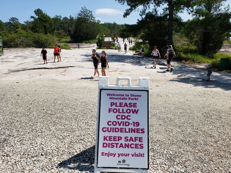 Visitors to Stone Mountain Park are reminded with signs about pandemic precautions on Sunday, September 6, 2020. (Photo: Matt Kempner/AJC)