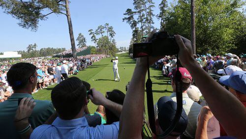 The crowd around the 18th tee watches Tiger Woods tee off during his practice round for the Masters at Augusta National Golf Club on Tuesday, April 3, 2018, in Augusta, Ga.  (Curtis Compton/Atlanta Journal-Constitution/TNS)