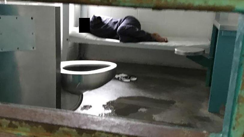 A woman lies on a thin mattress in her cell with water pooled at the foot of her metal bed, as seen during a midday visit at the South Fulton Municipal Regional Jail. This image is included in a federal lawsuit filed in April by the Georgia Advocacy Office and two women being held at the jail. The lawsuit includes graphic photos from a recent visit to the jail — among them this one — and details unimaginable conditions for the women detainees.