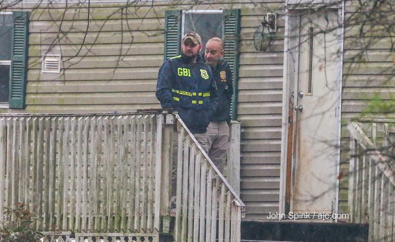GBI agents entered a home near the scene of a deadly deputy-involved shooting Tuesday. JOHN SPINK / JSPINK@AJC.COM