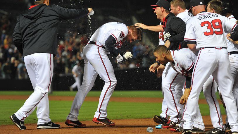 Atlanta Braves Freddie Freeman is doused by teammates following his walk off hit in the 10th inning to give the Braves a 3-2 win over the Chicago Cubs Friday May 9, 2014 at Turner Field.