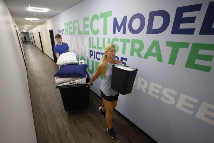 Mindy Doty from Milton, Ga., helps her son Will Doty bring his stuff to his dorm at the new building, The Summit at Kennesaw State University, on Wednesday, Aug. 10, 2022. (Miguel Martinez / miguel.martinezjimenez@ajc.com)