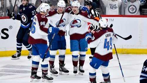 Colorado Avalanche Artturi Lehkonen (62) celebrates his goal against the Winnipeg Jets with Mikko Rantanen (96), Casey Mittelstadt (37) and Samuel Girard (49) during the second period in Game 5 of an NHL hockey Stanley Cup first-round playoff series in Winnipeg, Manitoba, Tuesday, April 30, 2024. (Fred Greenslade/The Canadian Press via AP)