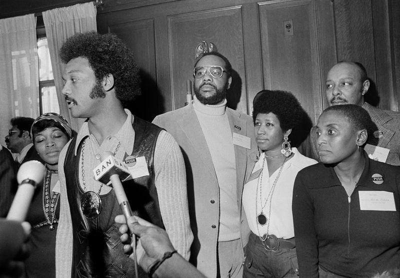 The Rev. Jesse Jackson speaks to reporters at the Operation PUSH Soul Picnic at the 142nd Street Armory in New York, March 26, 1972. Left to right are: Betty Shabazz, widow of Malcolm X; Jackson; Tom Todd, vice president of PUSH; Aretha Franklin; Miriam Makeba and Louis Stokes, rear right. PUSH stands for People United to Save Humanity. (AP Photo/Jim Wells) Photo: Jim Wells/AP