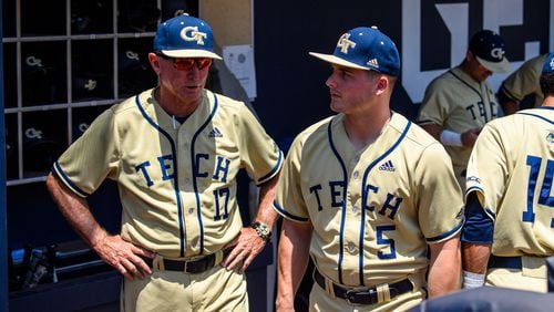 Georgia Tech coach Danny Hall (left) confers with son Colin, the Yellow Jackets center fielder, in the dugout of Russ Chandler Stadium during a game against North Carolina during the 2021 season. Tech opens NCAA regional play Friday. (Danny Karnik/Georgia Tech Athletics)