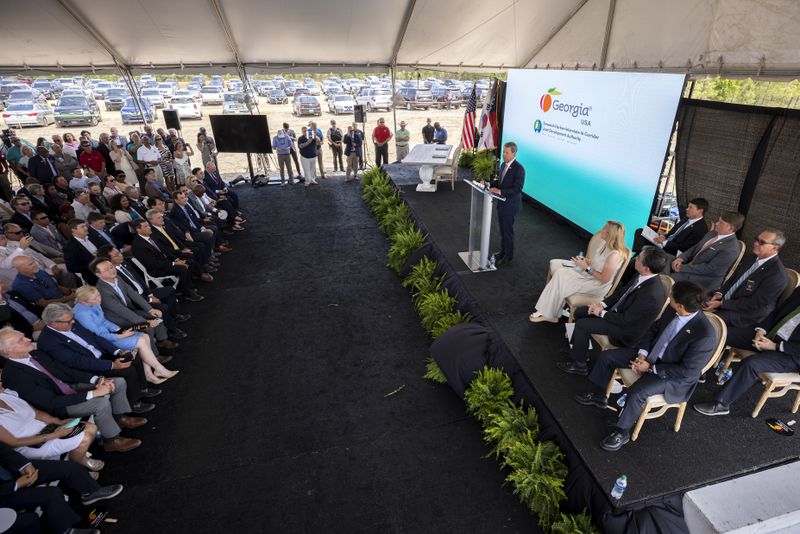 Gov. Brian Kemp, center right, announces that South Korean automaker Hyundai Motor Group is building an electric-vehicle plant in Ellabell, near Savannah. The Republican has hammered Georgia's two Democratic U.S. senators, Jon Ossoff and Raphael Warnock, over a provision of the climate and health care bill that Congress passed last year because it only provides a tax break to customers for electric vehicles assembled in the U.S. The Hyundai “Metaplant” won't be operational until 2025, so the tax break won't apply to its vehicles until then. (AJC Photo/Stephen B. Morton)