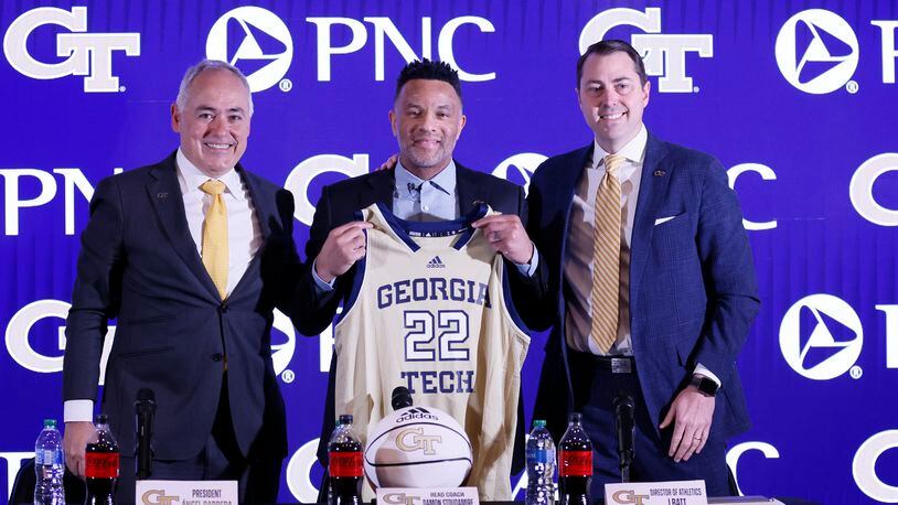 Georgia Tech President Ángel Cabrera and Director of Athletics J. Batt presented the jersey to the new basketball head coach Damon Stoudamire during a news conference on Tuesday, March 14, 2023.Miguel Martinez /miguel.martinezjimenez@ajc.com