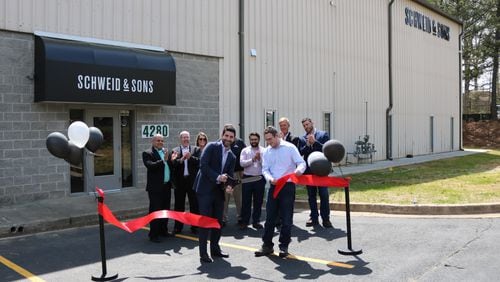 CEO Jamie Schweid of Schweid & Sons cuts the ribbon on the new processing facility in College Park. CONTRIBUTED