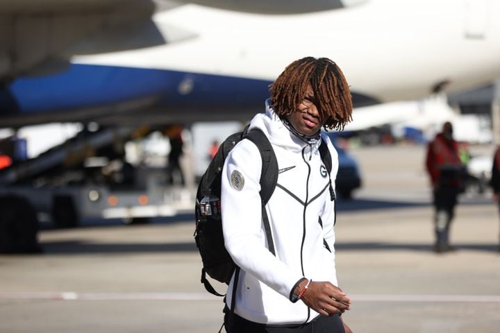 Georgia Bulldogs defensive back Lewis Cine looks over members of the press as the team arrives a day after their 33-18 win against the Alabama Crimson Tide at the 2022 College Football Playoff National Championship.