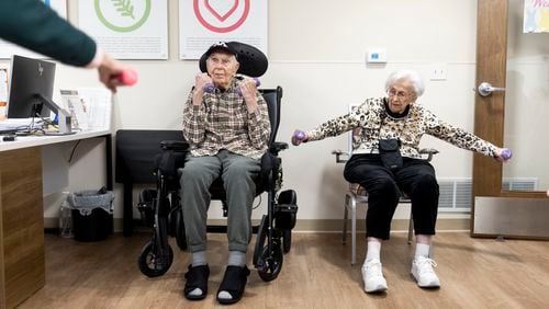 Florence Reiners and her husband, Donald, exercise in the memory unit at the Waters of Excelsior assisted living facility in Excelsior, Minnesota in March. Donald Reiners has since had to move away from his wife to a less expensive facility. (Tim Gruber for The New York Times)