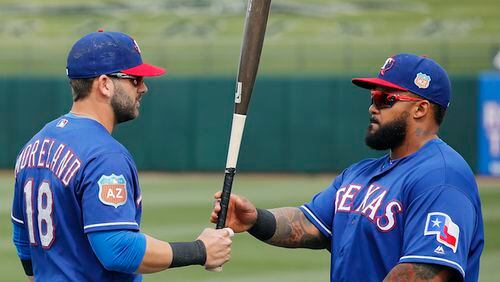 Texas Rangers' Mitch Moreland (18) talks with Prince Fielder, right, prior to a spring training baseball game against the San Francisco Giants Monday, March 7, 2016, in Surprise, Ariz. (AP Photo/Ross D. Franklin)