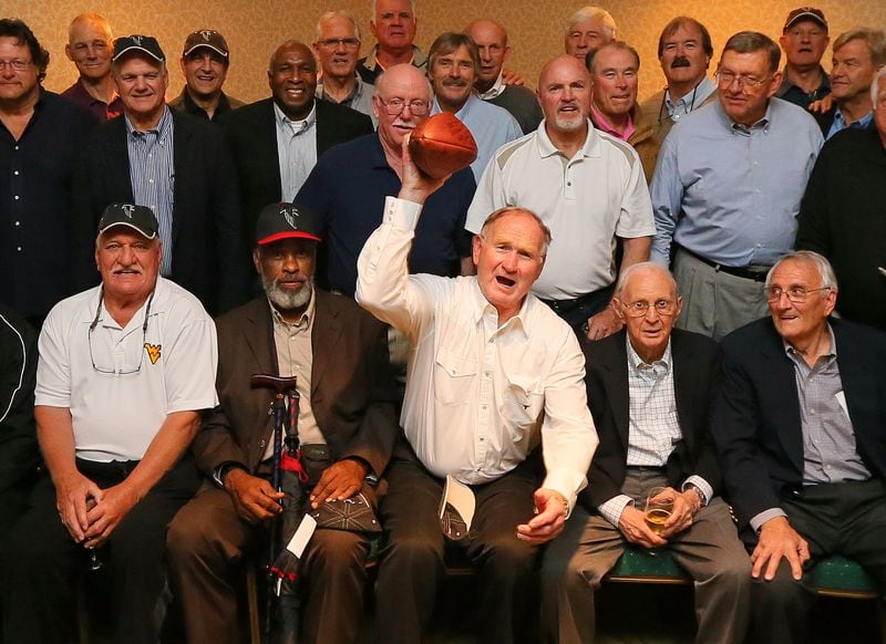 Tommy Nobis, center, hams it up during a portrait of early-era Falcons at a 2013 reunion.