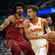Atlanta Hawks guard Trae Young, right, drives around Cleveland Cavaliers center Jarrett Allen (31) in the first half of an In-Season Tournament NBA basketball game, Tuesday, Nov. 28, 2023, in Cleveland. (AP Photo/Sue Ogrocki)