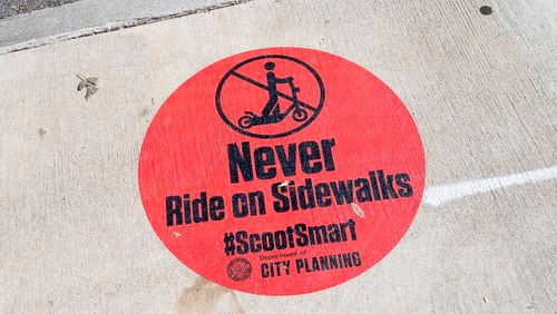 10/17/2019 -- Atlanta, Georgia -- A message from the Atlanta Department of City Planning is displayed on the sidewalk along {each tree Street NE in Atlanta's Midtown community, Thursday, October 17, 2019. (Alyssa Pointer/Atlanta Journal Constitution)