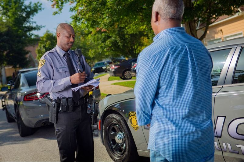 South Fulton police Cpl. Terrence Gibbons takes a report from a resident. The department has implemented a metrics system that relies heavily on statistics to fight crime.