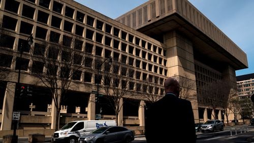 Man walks by FBI headquarters in Washington, D.C.