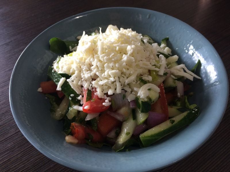 Cafe Raik’s house salad, essentially tomato, cucumber, onion and herbs, is topped with salty white cheese, and it is delightful. CONTRIBUTED BY WENDELL BROCK