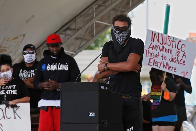 Atlanta Hawks guard Trae Young, center, speaks during a peaceful rally Monday, June 1, 2020, in his hometown of Norman, Okla., calling attention to the killing of George Floyd by Minneapolis police on May 25. (AP Photo/Sue Ogrocki)