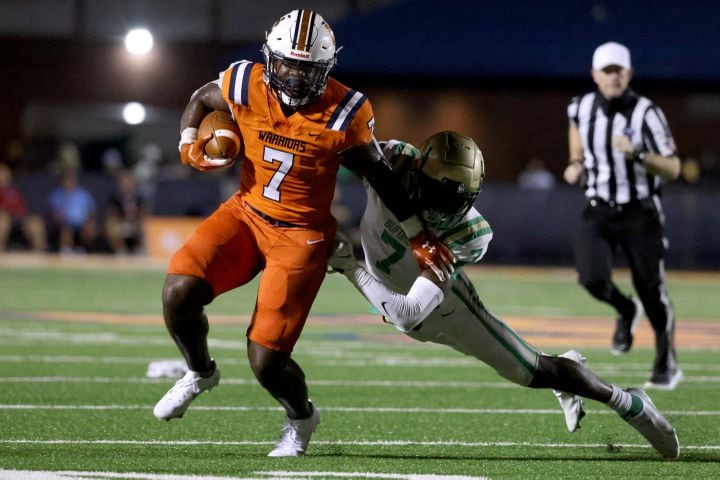 August 20, 2021 - Kennesaw, Ga: North Cobb running back Ben Hall (7) runs for a first down against Buford linebacker VJ Payne (7) during the first half at North Cobb high school Friday, August 20, 2021 in Kennesaw, Ga.. JASON GETZ FOR THE ATLANTA JOURNAL-CONSTITUTION