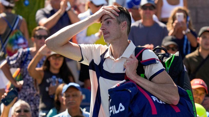 John Isner, of the United States, reacts after losing to Michael Mmoh, of the United States, during the second round of the U.S. Open tennis championships, Thursday, Aug. 31, 2023, in New York. (AP Photo/John Minchillo)