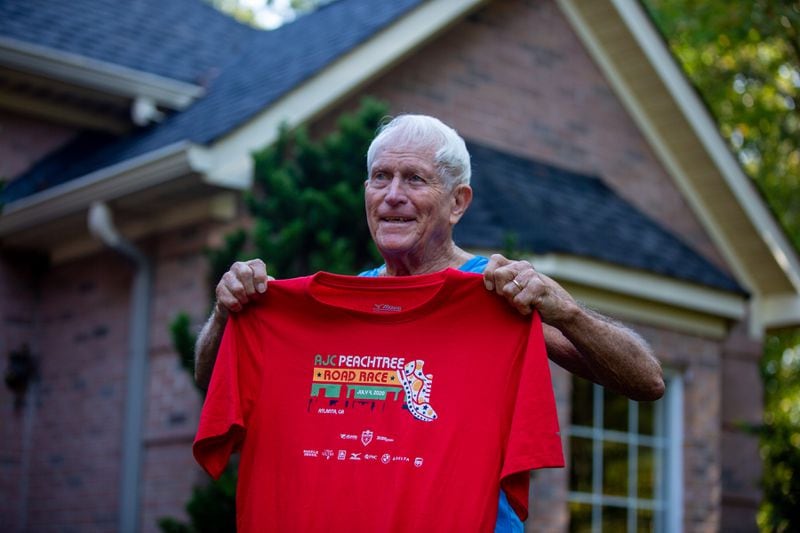 Bill Thorn holds up the Peachtree Road Race t-shirt in Tyrone, Georgia, on Tuesday, October 13, 2020. Bill Thorn was presented the t-shirt for the annual Peachtree Road Race on Tuesday by the Atlanta Track Club. (Photo/Rebecca Wright for the Atlanta Journal-Constitution)