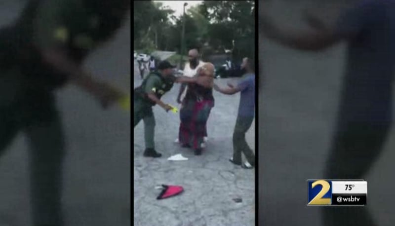 This is a screenshot of the video that appears to show an Atlanta police officer pushing Jennifer Barnwell. (Credit: Channel 2 Action News)