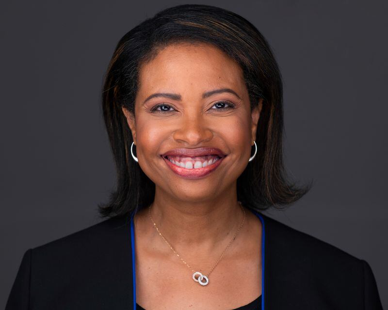 A headshot of Centers for Medicare & Medicaid Services Administrator, Chiquita Brooks-LaSure, smiling at the camera. In this photo she has short, strait, dark hair. She is wearing a black jacket with blue accents, silver hoop earrings, and a silver necklace.