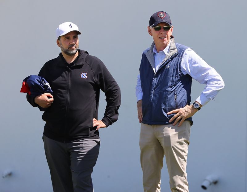 Braves GM Alex Anthopoulos (left) and Braves Chairman Terry McGuirk watch the first day of team practice at spring training on March 14 in North Port, Fla. (Curtis Compton / Curtis.Compton@ajc.com)