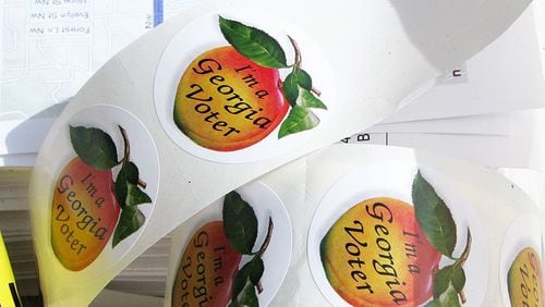 Georgia’s iconic election stickers are considered a badge of honor for many voters. (File Photo: AJC)