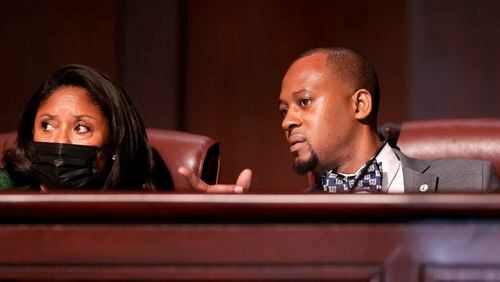 Council members Marci Collier Overstreet (left) and Antonio Lewis confer as the Atlanta City Council held their first in person meeting since they were suspended at start of the pandemic In Atlanta on Monday, March 21, 2022.   (Bob Andres / robert.andres@ajc.com)
