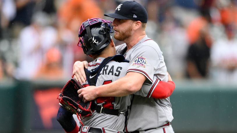Braves relief pitcher Will Smith (right) and catcher William Contreras celebrate 3-1 win over the Orioles, Sunday, Aug. 22, 2021, in Baltimore. (Nick Wass/AP)