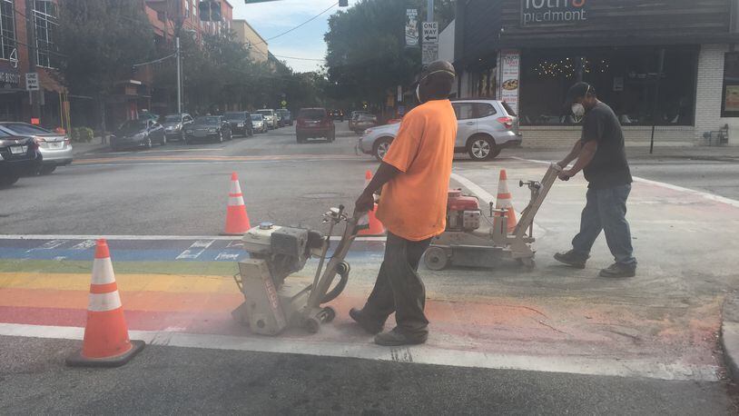 Construction crews on the intersection of 10th and Piedmont in Midtown erase the four rainbow crosswalks installed for Atlanta Pride on Saturday, October 24, 2015.