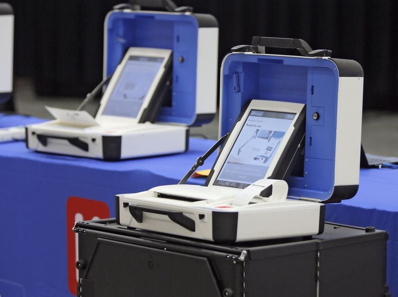Hart InterCivic offered a look at its voting machines, which use paper ballots that don’t feature a bar code. BOB ANDRES /BANDRES@AJC.COM