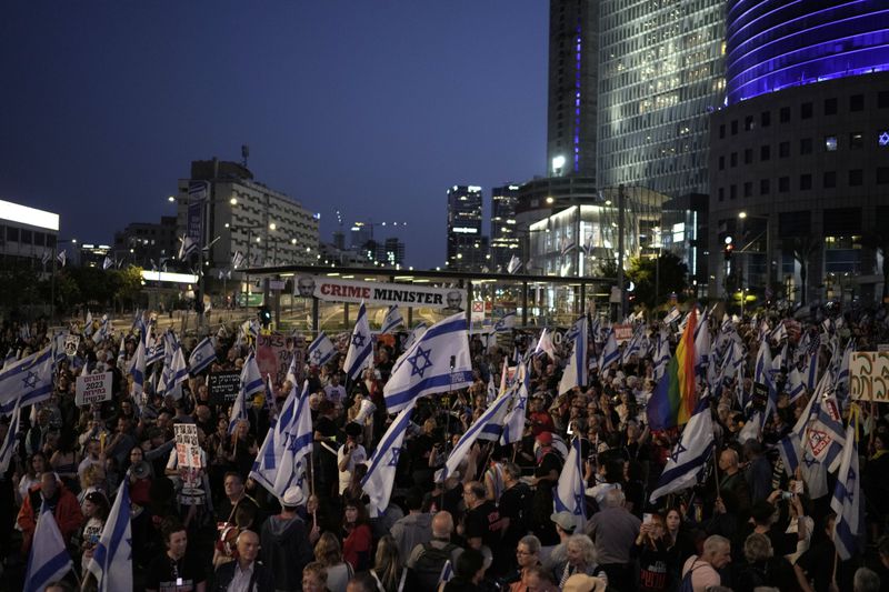 People protest against Israeli Prime Minister Benjamin Netanyahu's government and call for the release of hostages held in the Gaza Strip by the Hamas militant group, in Tel Aviv, Saturday, April 20, 2024. (AP Photo/Leo Correa)