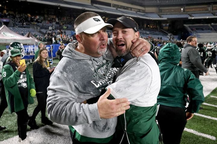 Collins Hill head coach Lenny Gregory, left, celebrates with defensive coordinator Drew Swick in the closing minute of their 24-8 win against Milton in the Class 7A state title football game at Georgia State Center Parc Stadium Saturday, December 11, 2021, Atlanta. JASON GETZ FOR THE ATLANTA JOURNAL-CONSTITUTION